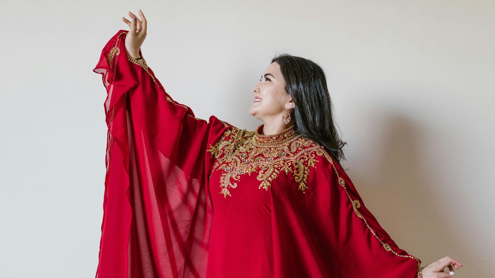 A chubby girl wearing a beautiful red Asian suit