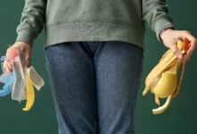 What Are the Challenges Facing Modern Waste Management? 2 A girl holding some waste promoting modern waste management practices