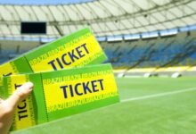 Why Do Football Tickets Sell Out So Quickly Worldwide? 3 A man holding football tickets in hand
