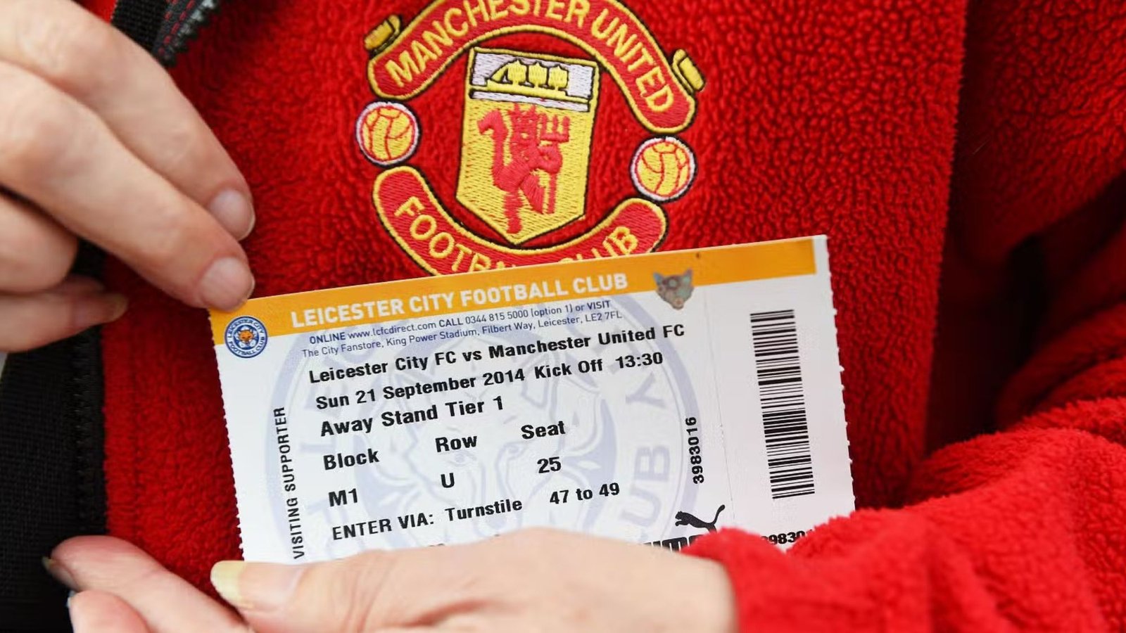 A person holding VIP football match tickets