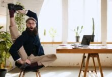 How Can You Create a Safe and Healthy Work Environment? 10 An employee stretching for work-life balance in a work environment to foster productivity & well-being