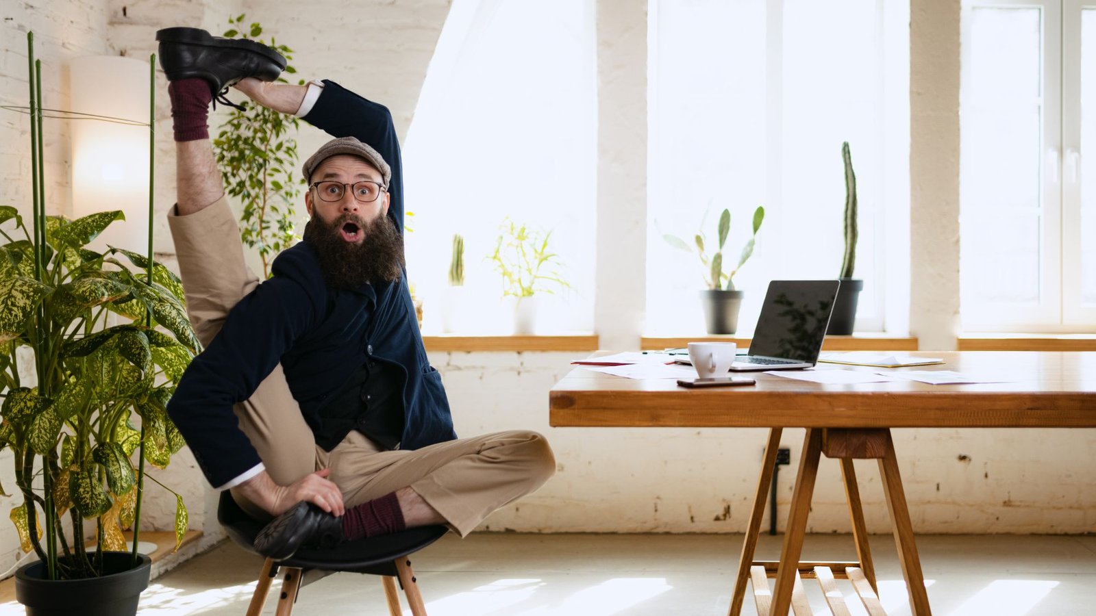 An employee stretching for work-life balance in a work environment to foster productivity & well-being